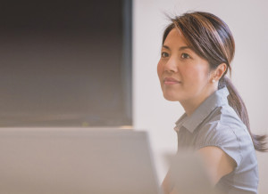 A woman next to a computer.