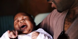 Andrew holds his newborn in a still from "MenCare Short: South Africa."